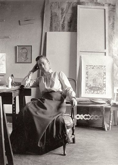 Hilma af Klint i sin ateljé på Hamngatan, 1895 - med en bild av sin farfar på väggen.